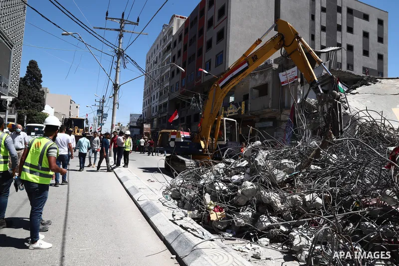 Egyptian bulldozers remove rubble from a building destroyed during the May 2021 conflict between Hamas and Israel, in Gaza City on June 5, 2021. Egypt sent an aid convoy to neighbouring Gaza with diggers, trucks and cran...