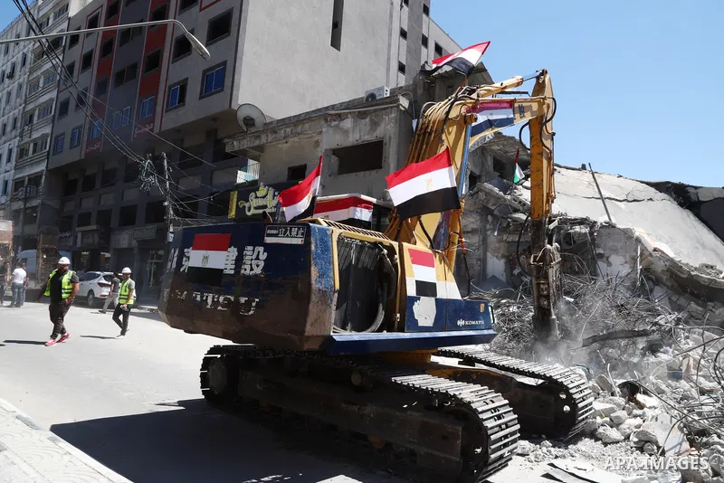 Egyptian bulldozers remove rubble from a building destroyed during the May 2021 conflict between Hamas and Israel, in Gaza City on June 5, 2021. Egypt sent an aid convoy to neighbouring Gaza with diggers, trucks and cran...