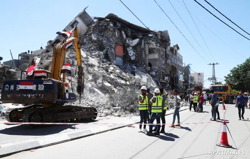 Egyptian bulldozers remove rubble from a building destroyed during the May 2021 conflict between Hamas and Israel, in Gaza City on June 5, 2021. Egypt sent an aid convoy to neighbouring Gaza with diggers, trucks and cran...