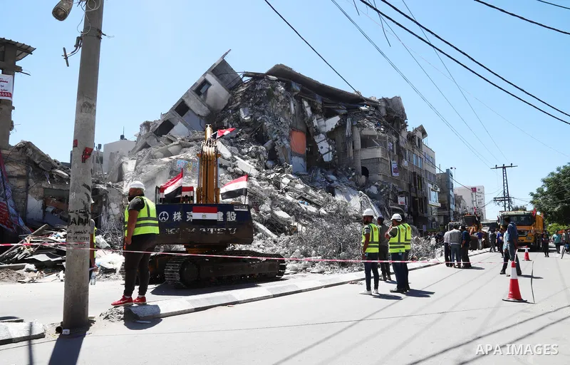 Egyptian bulldozers remove rubble from a building destroyed during the May 2021 conflict between Hamas and Israel, in Gaza City on June 5, 2021. Egypt sent an aid convoy to neighbouring Gaza with diggers, trucks and cran...
