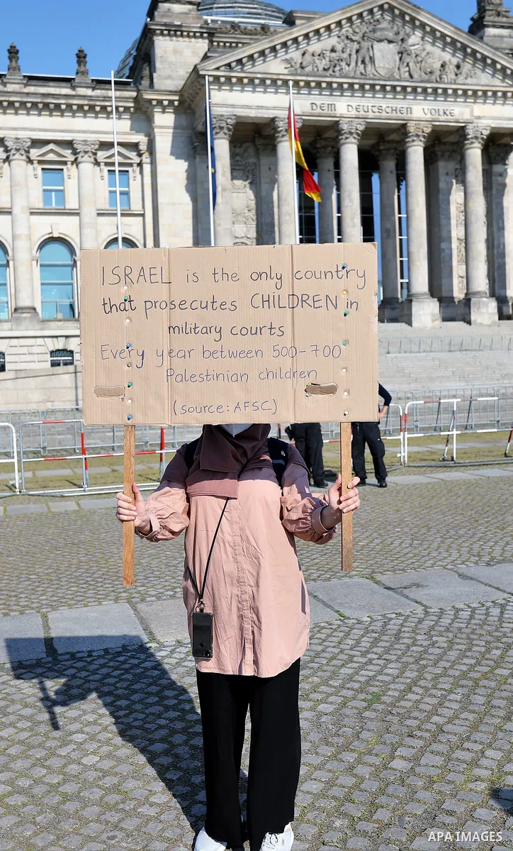 Foreign activists take part during a protest against the killed of Palestinian children at Gaza city by Israeli airstrikes, in front of German Bundestag, in Berlin, Germany, on June 4, 2021. Photo by Manar Shahin