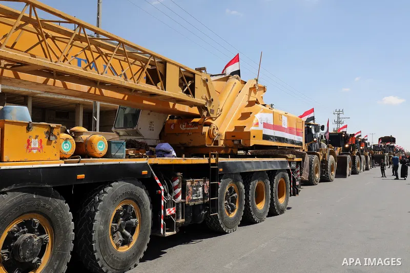 A convoy of bulldozers, excavators and trucks loaded with construction equipment provided by Egypt arrives at the Palestinian side of the Rafah border crossing between Egypt and the Palestinian Gaza Strip enclave on June...