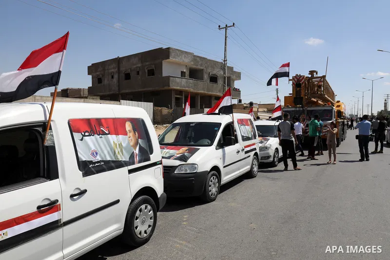 A convoy of bulldozers, excavators and trucks loaded with construction equipment provided by Egypt arrives at the Palestinian side of the Rafah border crossing between Egypt and the Palestinian Gaza Strip enclave on June...