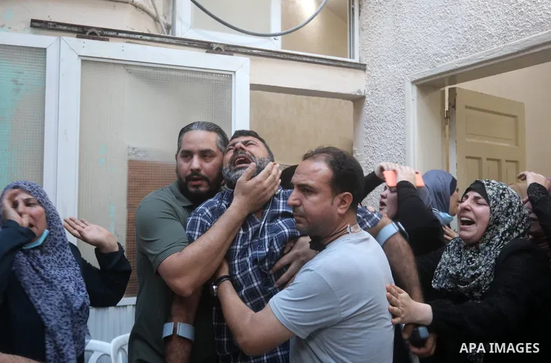 Relatives of Ahmad Zaki Abu Hassera, one of the two fighters who died after reportedly dismantling a bomb dropped by Israeli forces, mourn during his funeral in Gaza City on June 2, 2021. Photo by Mahmoud Nasser
