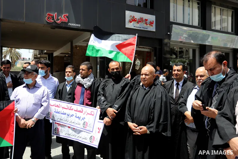 Palestinian lawyers take part in a protest against Israeli violations, in front of Jala' Tower which destroyed which destroyed on May 15 during Israeli air-strike in Gaza city on June 1, 2021. As Gaza tries to recover fr...