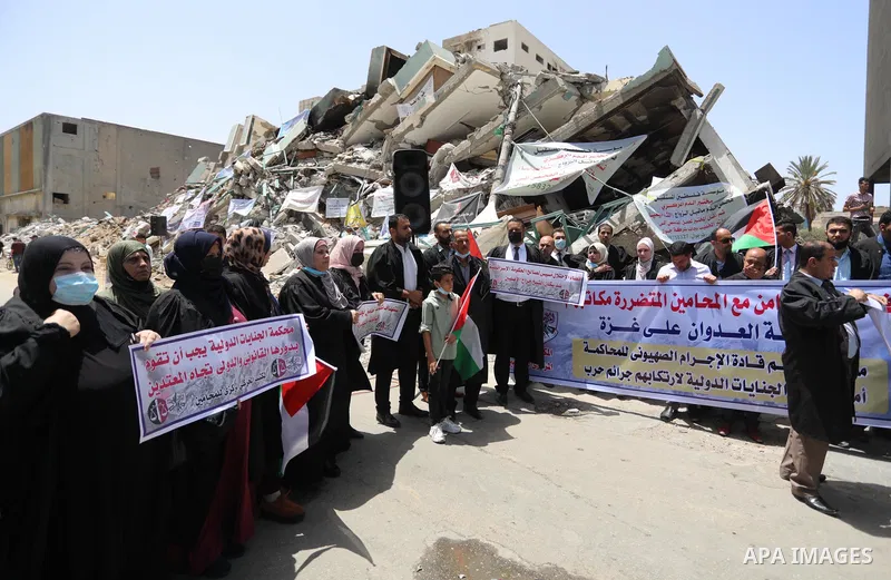 Palestinian lawyers take part in a protest against Israeli violations, in front of Jala' Tower which destroyed which destroyed on May 15 during Israeli air-strike in Gaza city on June 1, 2021. As Gaza tries to recover fr...