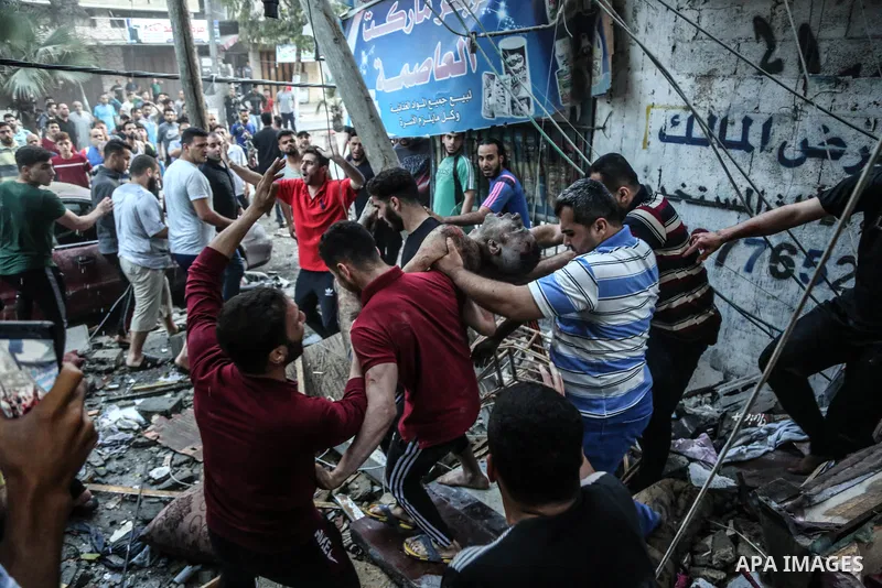 Palestinians recover the body of Journaliste Yousef Abu Hussein a amid rubble at the site of Israeli air strikes, in Gaza City May 19, 2021. Photo by Bashar Taleb