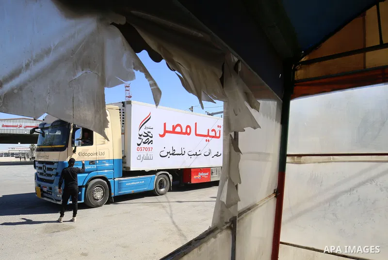 An aid convoy's trucks loaded with supplies, send by Long Live Egypt Fund, are seen at the Rafah border crossing between Egypt and the Gaza Strip, on May 23, 2021. Photo by Abed Deeb