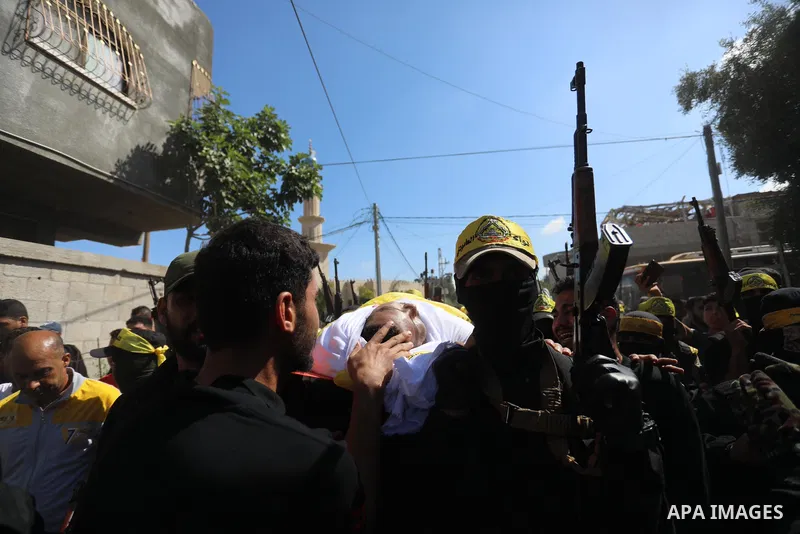 Relatives carry the body of Palestinian Mahmoud Abu Jarad during his funeral in Beit Hanun in the northern Gaza Strip on May 24, 2021, after he died from wounds sustained during the latest conflict with Israel. Photo by...
