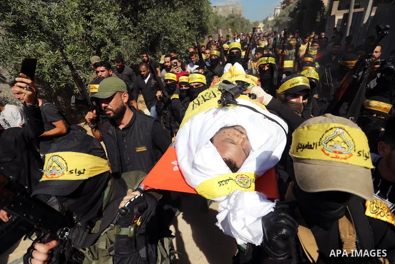 Relatives carry the body of Palestinian Mahmoud Abu Jarad during his funeral in Beit Hanun in the northern Gaza Strip on May 24, 2021, after he died from wounds sustained during the latest conflict with Israel. Photo by...