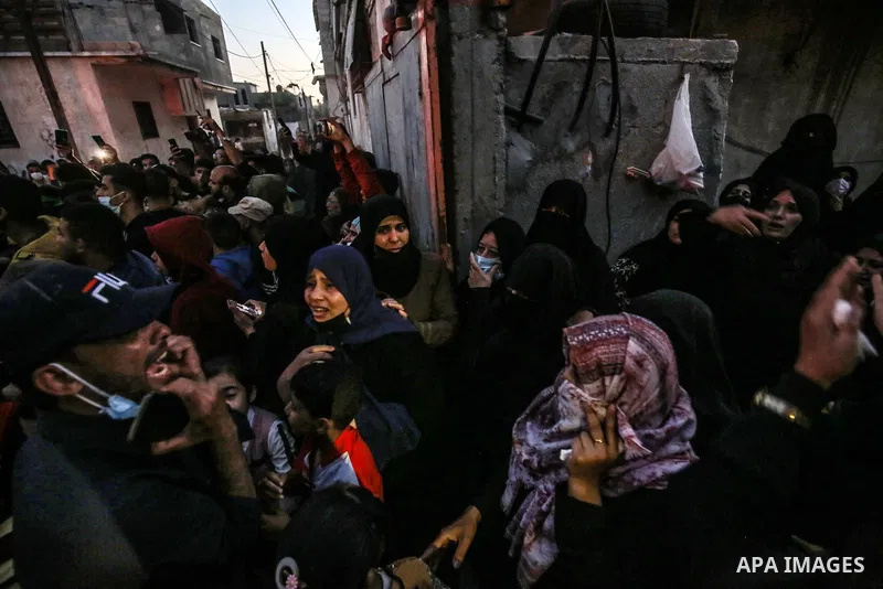 Palestinian relatives of members of the Ezz-Al Din Al-Qassam Brigades, the armed wing of the Hamas movement, who reportedly died in Israeli bombardment of a tunnel, mourn during their funeral, in Khan Yunis, in the south...