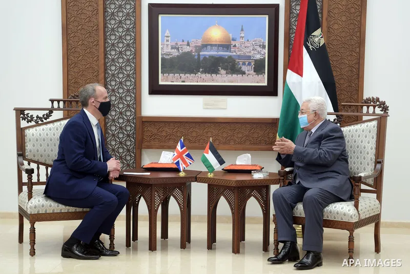 Palestinian President Mahmoud Abbas, meets with British Foreign Secretary Dominic Raab, in the West Bank city of Ramallah, on May 26, 2021. Photo by Thaer Ganaim