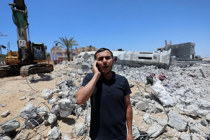 Palestinian Muslim worshippers pray near the rubble of a mosque which was destroyed by Israeli air strikes in Beit Lahia, in the northern Gaza Strip on May 27, 2021. A ceasefire was reached late last week after 11 days o...