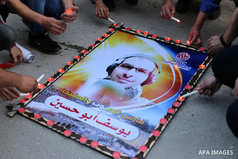 Palestinian Journalists light candles in a protest on the Violation against Media Freedoms during the Escalation on the Gaza Strip, in front of Jala' Tower which destroyed on May 15 during Israeli air-strike in Gaza city...