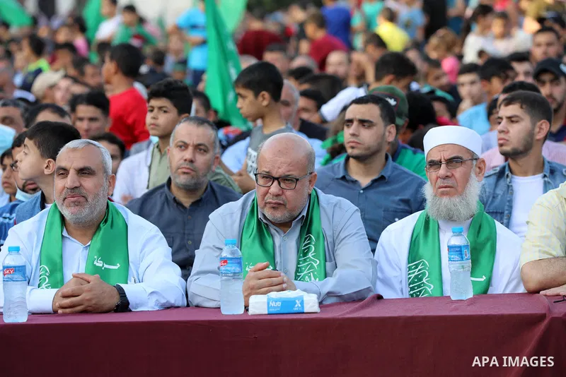 Palestinian supporters of the Ezz-Al Din Al-Qassam Brigades, the armed wing of the Palestinian Hamas movement parade in an anti-Israel rally Al-Bureij refugee camp in the central Gaza Strip on May 28, 2021. - The Egyptia...