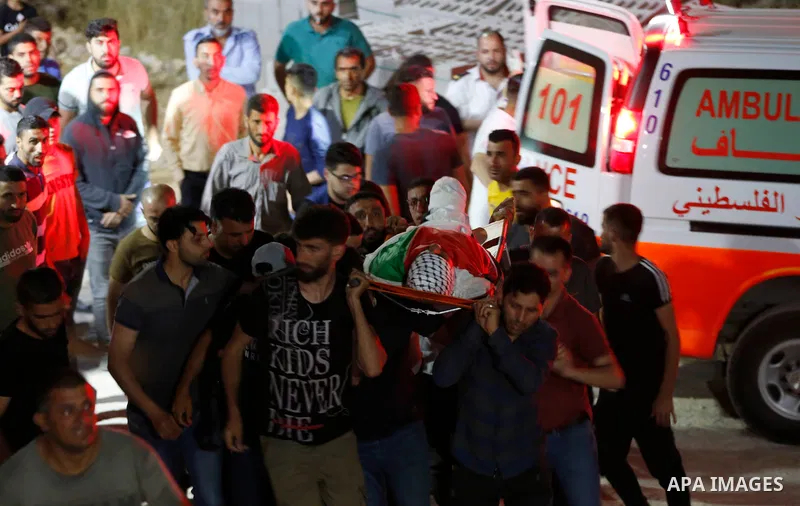 Relatives of 28-year-old Zakaria Hamayel, who was struck by a bullet to the chest by Israeli forces during a protest against settlement expansion, attend his funeral in the village of Baita, south of Nablus, in the occup...