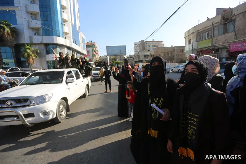 Supporters of al-Quds Brigades, the armed wing of the Palestinian Islamic Jihad movement, gather to watch them parade in the streets of Gaza City on May 29, 2021, more than a week after a ceasefire brought an end to 11 d...
