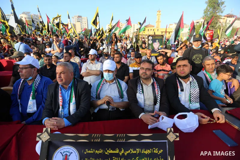 Supporters of al-Quds Brigades, the armed wing of the Palestinian Islamic Jihad movement, gather to watch them parade in the streets of Gaza City on May 29, 2021, more than a week after a ceasefire brought an end to 11 d...