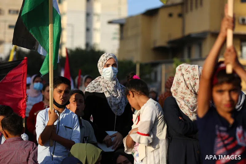 Supporters of al-Quds Brigades, the armed wing of the Palestinian Islamic Jihad movement, gather to watch them parade in the streets of Gaza City on May 29, 2021, more than a week after a ceasefire brought an end to 11 d...