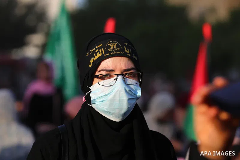 Supporters of al-Quds Brigades, the armed wing of the Palestinian Islamic Jihad movement, gather to watch them parade in the streets of Gaza City on May 29, 2021, more than a week after a ceasefire brought an end to 11 d...
