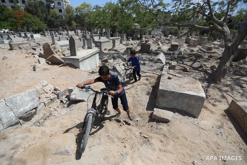 Palestinians inspect the damage around tombs in the old Shujaiya cemetery in Gaza City on May 30, 2021, after recent Israeli bombings. A ceasefire was reached late last week after 11 days of deadly violence between Israe...