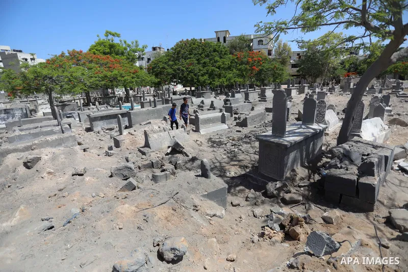 Palestinians inspect the damage around tombs in the old Shujaiya cemetery in Gaza City on May 30, 2021, after recent Israeli bombings. A ceasefire was reached late last week after 11 days of deadly violence between Israe...