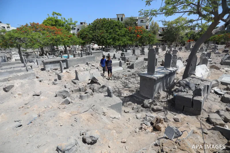 Palestinians inspect the damage around tombs in the old Shujaiya cemetery in Gaza City on May 30, 2021, after recent Israeli bombings. A ceasefire was reached late last week after 11 days of deadly violence between Israe...