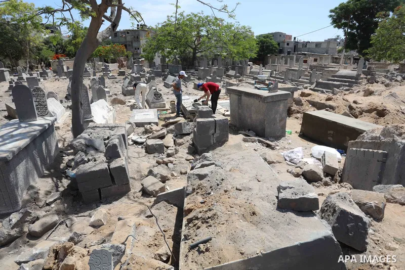 Palestinians inspect the damage around tombs in the old Shujaiya cemetery in Gaza City on May 30, 2021, after recent Israeli bombings. A ceasefire was reached late last week after 11 days of deadly violence between Israe...