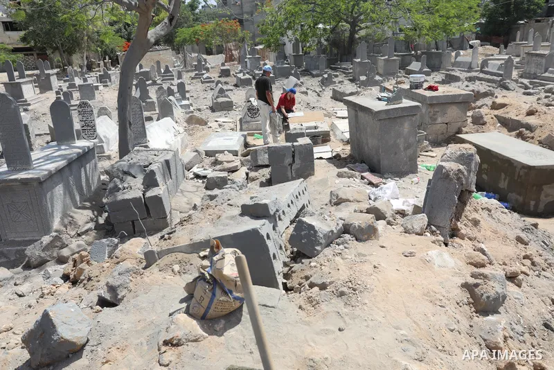 Palestinians inspect the damage around tombs in the old Shujaiya cemetery in Gaza City on May 30, 2021, after recent Israeli bombings. A ceasefire was reached late last week after 11 days of deadly violence between Israe...