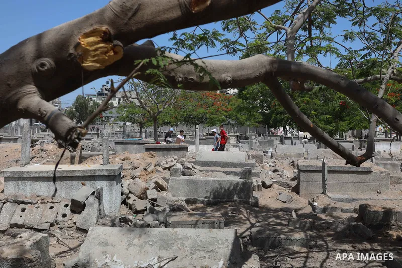 Palestinians inspect the damage around tombs in the old Shujaiya cemetery in Gaza City on May 30, 2021, after recent Israeli bombings. A ceasefire was reached late last week after 11 days of deadly violence between Israe...