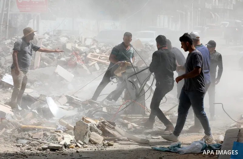 Palestinian workers remove rubble of the Abu Al-Aouf building, that was destroyed by Israeli air strikes, in Gaza City, on May 31, 2021. Gaza’s housing ministry said on Thursday that 16,800 housing units had been damaged...