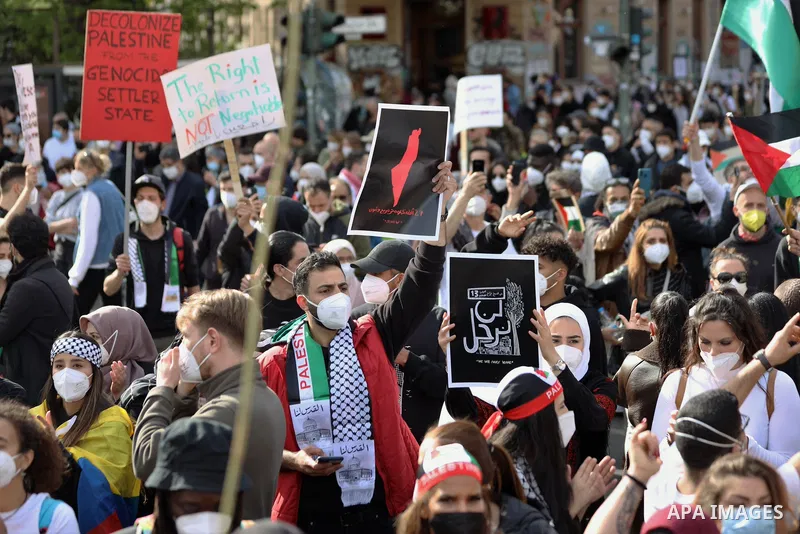 People attend a protest rally in solidarity with Palestinians in Berlin, Germany, Saturday, May 15, 2021. According to the Palestinian Ministry of Health, at least 140 Palestinians, including 39 children, were killed in...