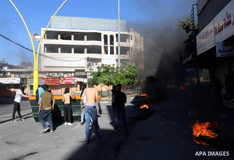 Palestinian protesters clash with Israeli soldiers in solidarity with Gaza strip and jerusalem near Bab Al-Zawiya, in the West Bank city of Hebron, on May 15, 2021. In response to days of violent confrontations between I...