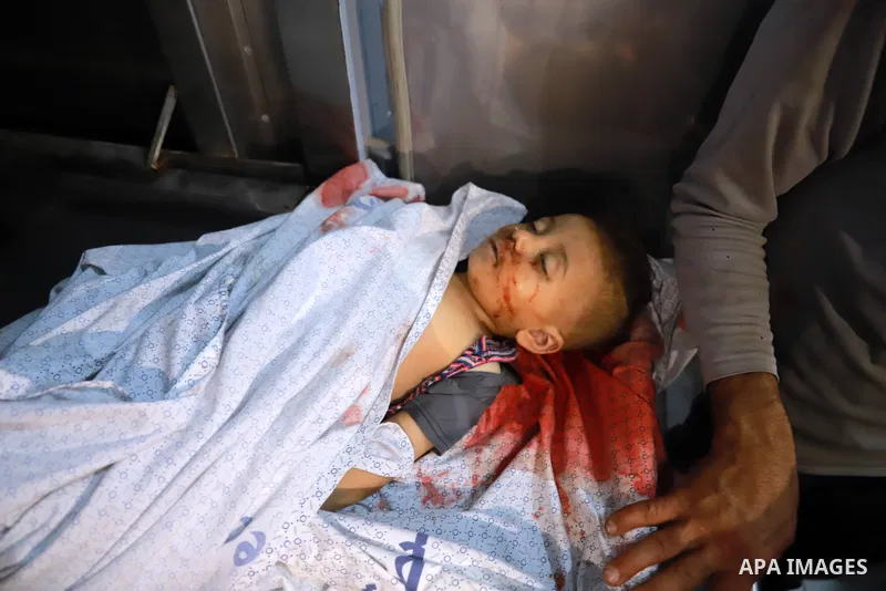 A Palestinian man cries over the body of children killed amid a flare-up of Israeli-Palestinian violence, at a hospital morgue in the northern Gaza Strip, on May 10, 2021. - Nine people were killed amid air raids in the...
