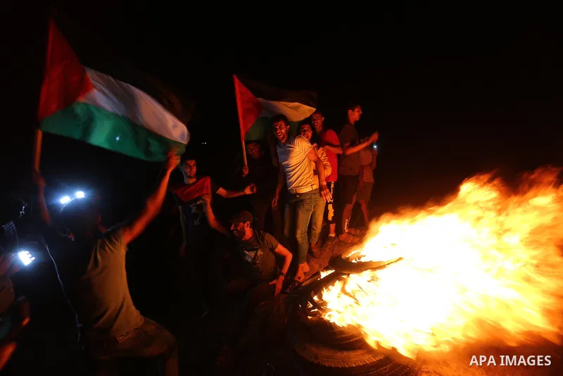 Palestinian protesters burn tires during a demonstration along the Israel-Gaza border, east of Al-Bureij camp, in the center of the Gaza Strip in solidarity the Palestinians in Jerusalem's Sheikh Jarrah neighbourhood, wh...