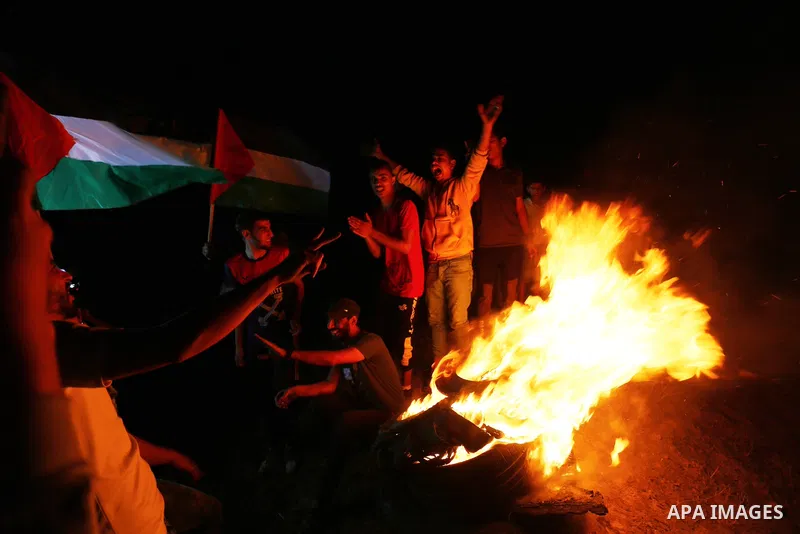 Palestinian protesters burn tires during a demonstration along the Israel-Gaza border, east of Al-Bureij camp, in the center of the Gaza Strip in solidarity the Palestinians in Jerusalem's Sheikh Jarrah neighbourhood, wh...