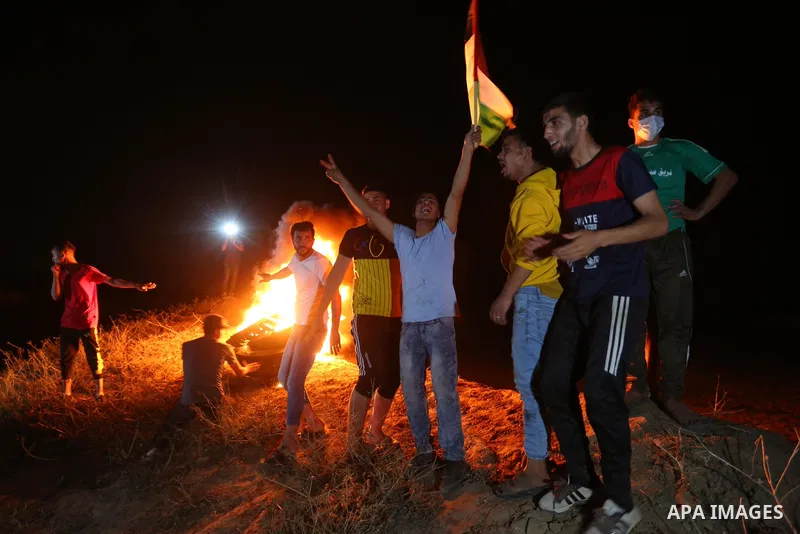 Palestinian protesters burn tires during a demonstration along the Israel-Gaza border, east of Al-Bureij camp, in the center of the Gaza Strip in solidarity the Palestinians in Jerusalem's Sheikh Jarrah neighbourhood, wh...