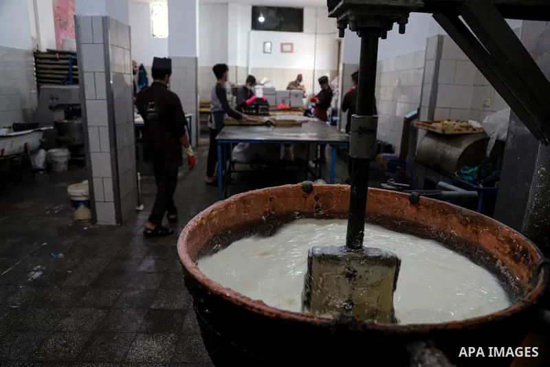 Palestinians prepare sweet known in Arabic as "Halkoum" to be sold ahead of the Eid al-Fitr holiday, at a factory in Gaza City on May 09, 2021. Eid al-Fitr this year is different in light of the COVID-19 pandemic. Eid al...