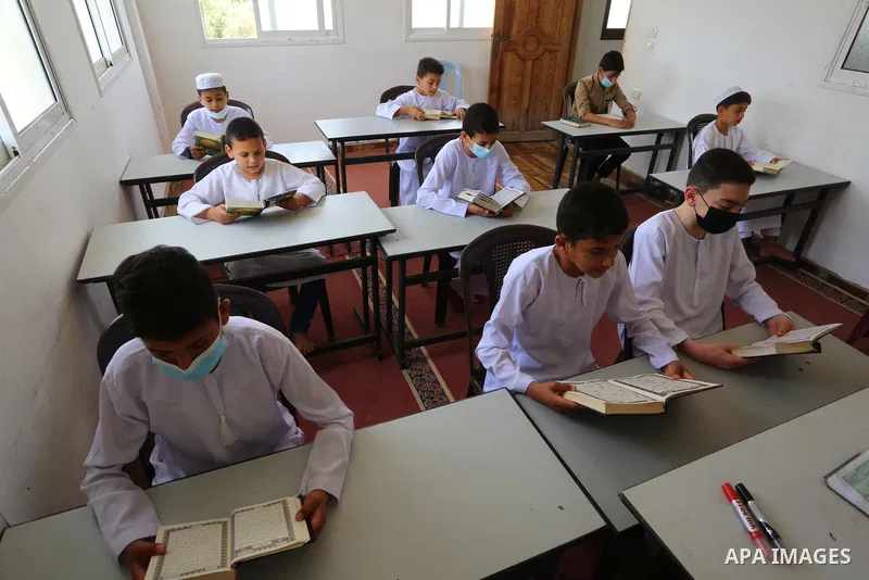Palestinian children read holy Koran in mosque during the holy month of Ramadan amid the coronavirus COVID-19 pandemic, in Deir al-Balah in the center of Gaza Strip on May 09, 2021. Photo by Ashraf Amra