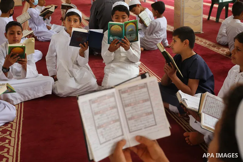 Palestinian children read holy Koran in mosque during the holy month of Ramadan amid the coronavirus COVID-19 pandemic, in Deir al-Balah in the center of Gaza Strip on May 09, 2021. Photo by Ashraf Amra