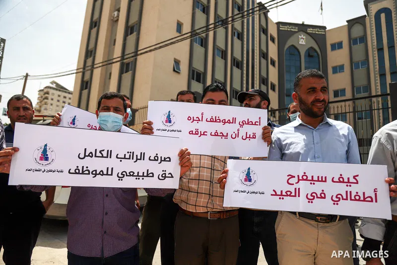 Palestinian employees in the Gaza Strip, take part in a protest demanding a payment before Eid Al-Fitr, in front of the Ministry of Finance headquarters, in Gaza city, on May 9, 2021. The union of public sector employees...