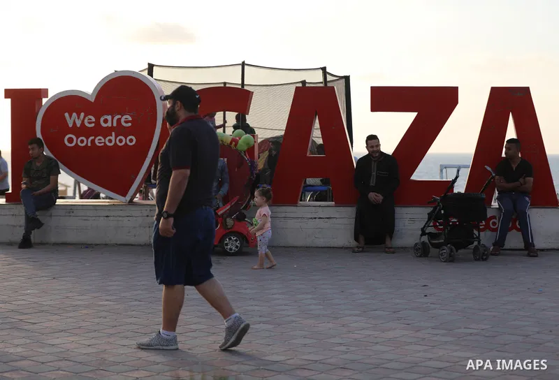 Palestinians walk after a lockdown due to the coronavirus was lifted, during the Muslim holy month of Ramadan, at the beach in the Gaza city, on May 8, 2021. COVID-19 has claimed the lives of 13 people in Palestine in th...