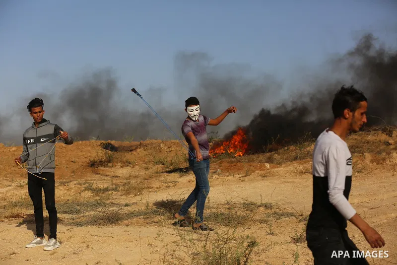 Palestinians demonstrate along the Israel-Gaza border, east of Khan Yunis town in the southern Gaza Strip on May 8, 2021. - Israel braced for more protests after clashes at Jerusalem's flashpoint Al-Aqsa Mosque compound...
