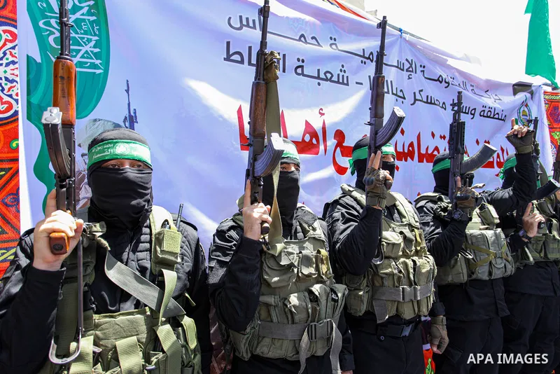 Palestinians and members of Ezz-Al Din Al-Qassam Brigades, the armed wing of the Hamas movemen take part in a prtoest in solidarity with Sheikh Jarrah neighbourhood, in Jabalia in the nothern of Gaza Strip on May 07, 202...