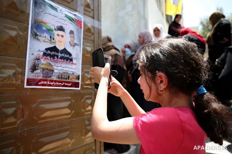 Mourners carry the body 16-year-old Said Youssef Muhammad Oudeh on a stretcher, during his funeral in the northern Odla area of the occupied West Bank city of Nablus, on May 6, 2021. - The Israeli army shot and killed th...