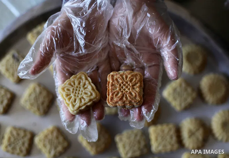 Palestinian women prepare traditional date-filled mini cakes, ahead of Eid al Fitr in Gaza City amid the COVID-19 pandemic on May 06, 2021. Eid al-Fitr this year is different in light of the COVID-19 pandemic. Eid al-Fit...