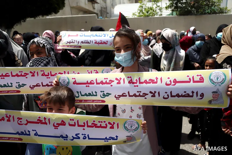 Supporters of Democratic Reformist Current, take part in a protest against postponement of the Palestinian parliamentary and presidential elections in front of the Ministry of Labor, in Gaza city, on May 5, 2021. Palesti...