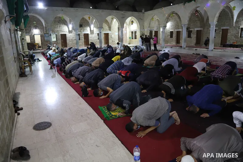 Palestinian Muslim worshipers attend the night prayer known as 'Taraweeh' at a mosque during the holy month of Ramadan, in Gaza City, on 04 May 2021. after the the decision of authorities in the Gaza Strip to eased tight...