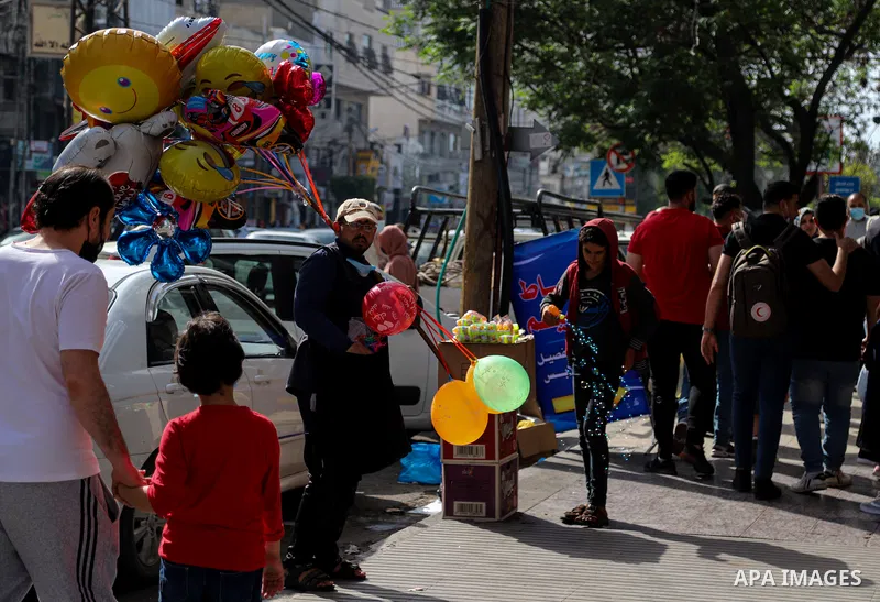 Palestinians shop at market days before of Eid al Fitr in Gaza City amid the COVID-19 pandemic on May 04, 2021. People flock markets and shopping malls as they shop for food and new clothings in preparation for Eid al Fi...