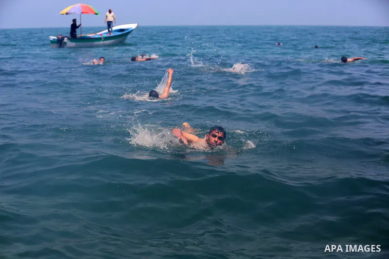 Palestinian swimmers compete during sea rescuer competition, which was organize by Ministry of Local Government with the Navy Police to choose a sea rescuer in Deir al-Balah in the center of Gaza Strip, on May 3, 2021. T...